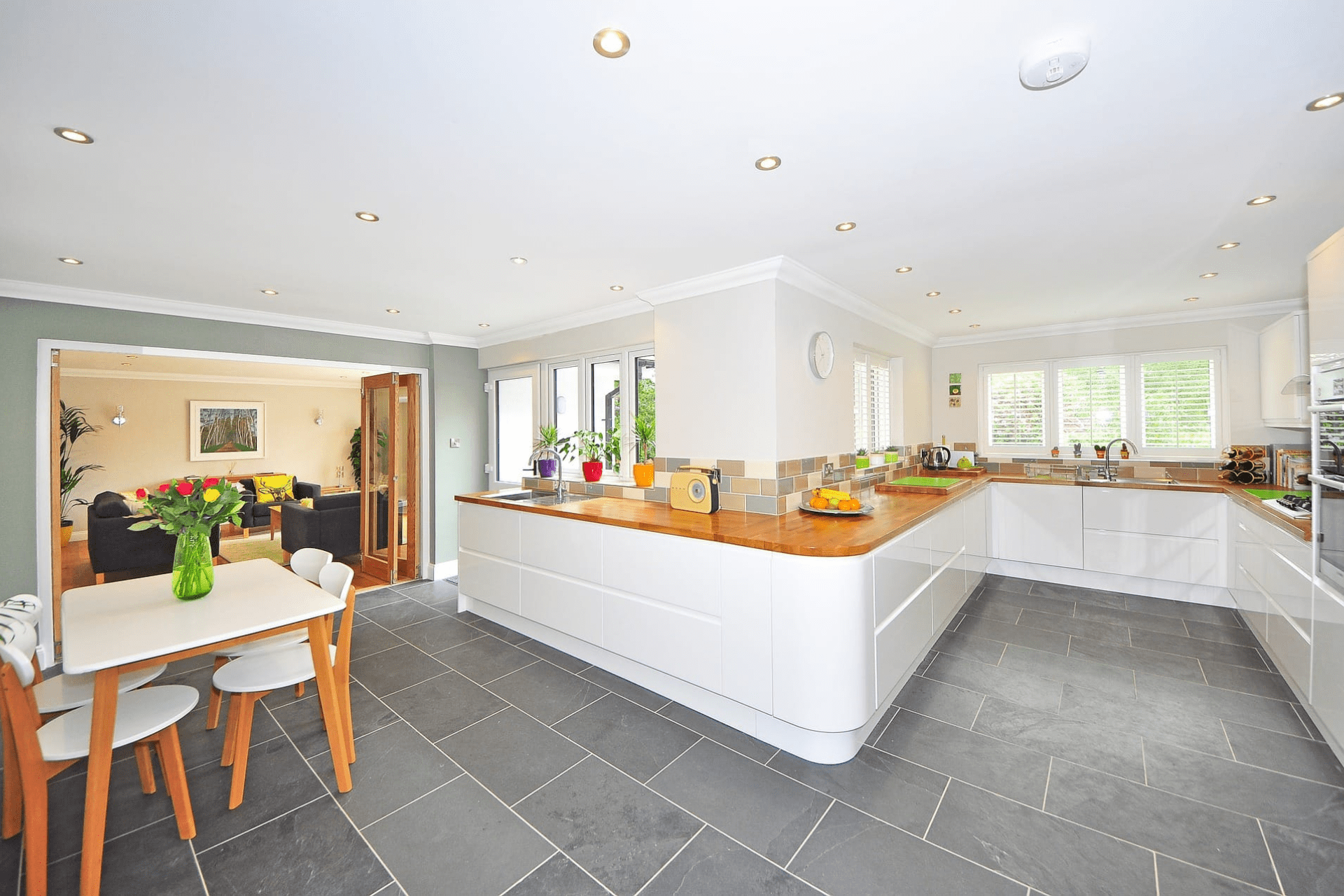 A kitchen that has had its cabinets sprayed white in Swansea